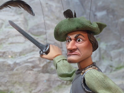 man in green and gray suit holding sword vinyl figure thumbnail
