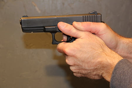 person holding black semi-automatic pistol thumbnail