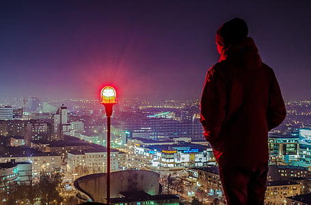 silhouette of person near red LED light at nighttime thumbnail