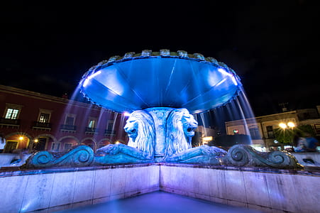 lion fountain with blue light at night thumbnail