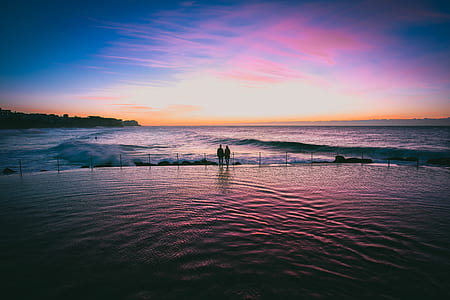 silhouette of coupe standing on platform near sea waves thumbnail