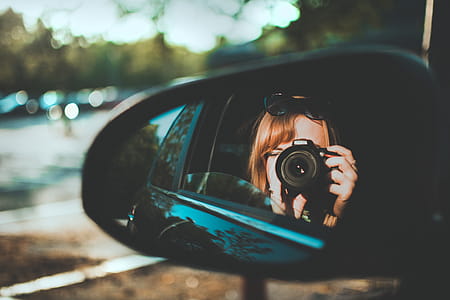 Selective Focus Photography of Woman Taking Camera Through Mirror thumbnail