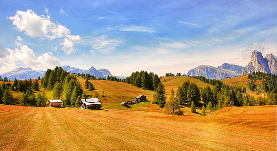 brown house on field across mountains thumbnail