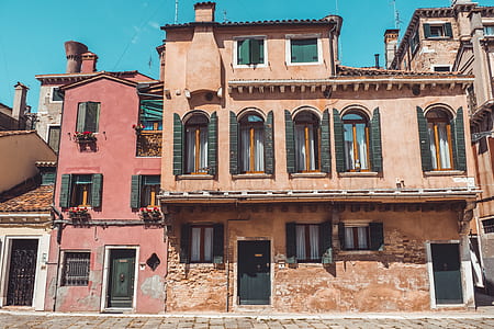 orange concrete building beside red concrete building thumbnail