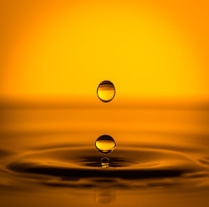 macro photography of yellow liquid droplet thumbnail