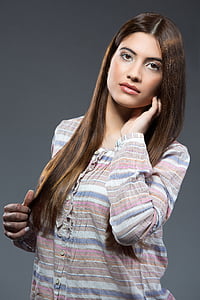 woman wearing brown, pink, and blue striped long-sleeved shirt thumbnail