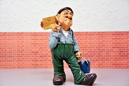man holding bucket and mop figurine on gray surface thumbnail