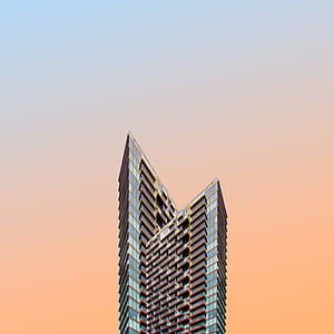 gray and red high-rise building with orange background thumbnail