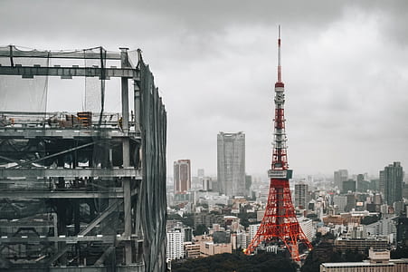 Tokyo tower surrounded with buildings under gray cloudy sky during daytime thumbnail