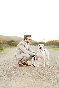 man wearing gray formal suit jacket beside his dog thumbnail