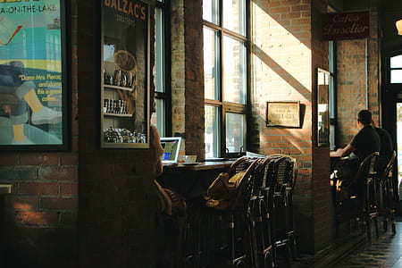 brown wooden chairs near window thumbnail