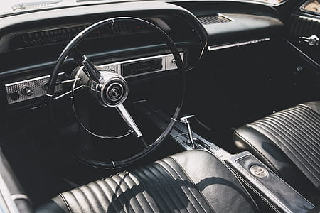 black steering wheel and black leather bucket seat thumbnail