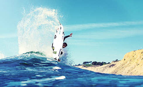 man riding wakeboard on body of water thumbnail
