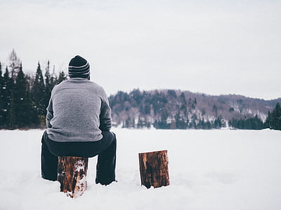 man wearing gray sweater sitting on brown tree branch thumbnail
