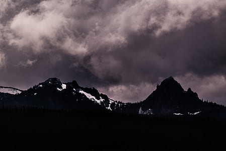 silhouette of mountains under nimbus clouds thumbnail