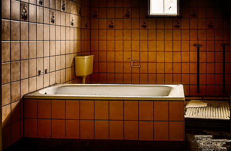 bathtub beside wall in room thumbnail