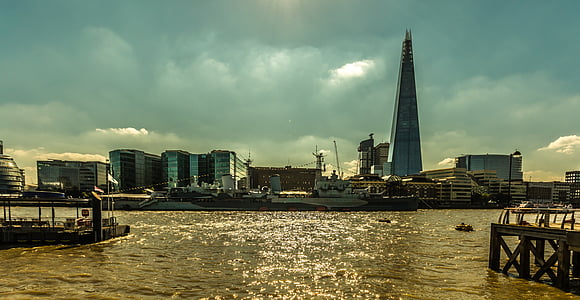 triangular building near body of water at daytime photo thumbnail