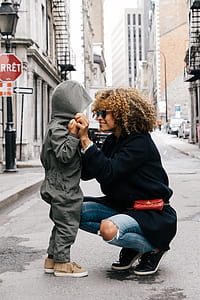 woman kneeling while looking at child thumbnail