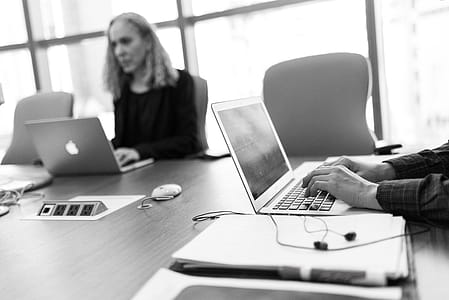 Grayscale Photo of Person Using Laptop Computer thumbnail