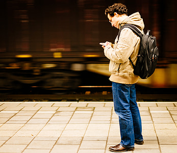 man standing white using smartphone thumbnail