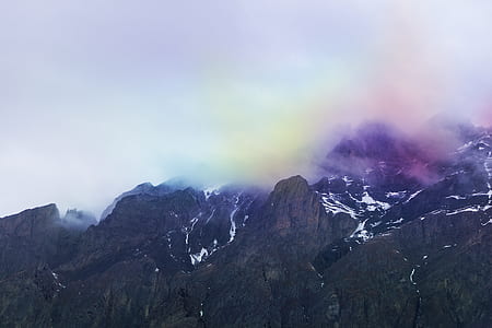 mountain landscape with peak covered with clouds during daytime thumbnail