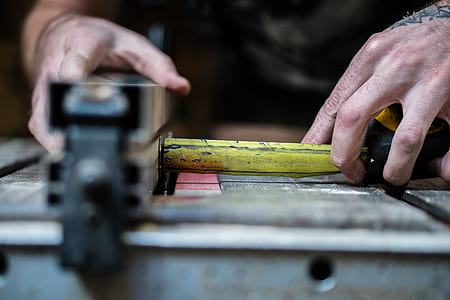 person holding yellow and gray steel tool thumbnail