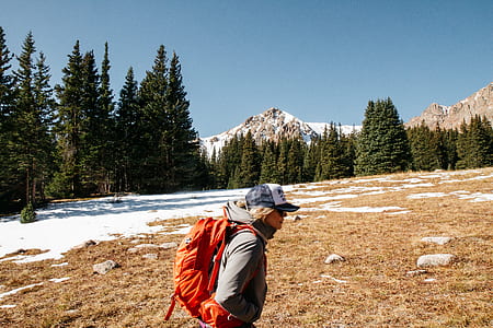 woman carrying orange backpack thumbnail