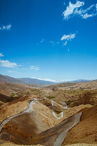 aerial photography of mountains with paved roads thumbnail