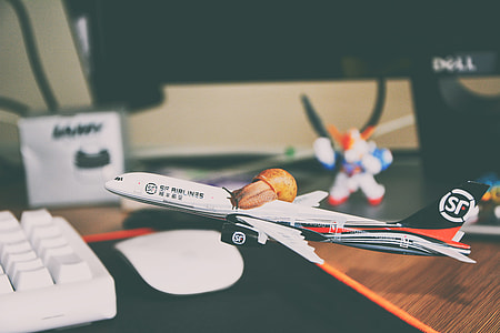 white and red plastic QC Airliners scale model on desk thumbnail