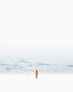 person standing in front of ice berg thumbnail