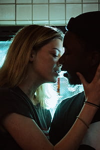 man and woman kissing in room thumbnail