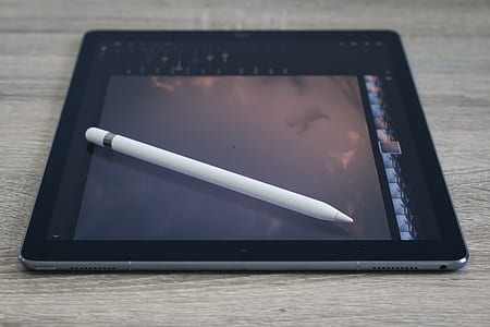 black iPad on brown surface thumbnail
