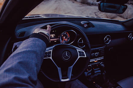 person holding black Mercedes-Benz steering wheel thumbnail