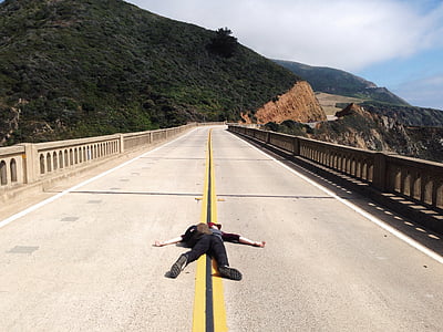 person lying on bridge at daytime thumbnail