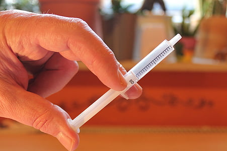 person holding syringe thumbnail
