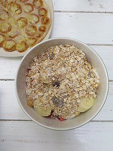 oat meal in white ceramic bowl and slice banana thumbnail