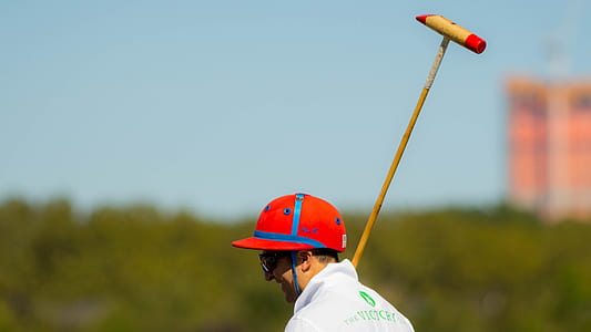 selective focus photo of man holding bat thumbnail