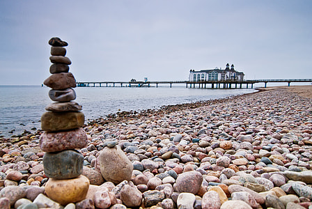 low light photography of stack of rocks on beach thumbnail