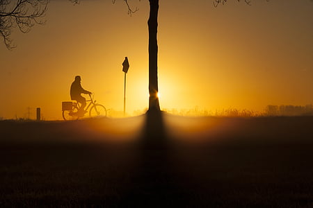 silhouette of person riding bicycle thumbnail