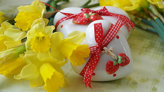 yellow daffodil flowers beside heart figurines thumbnail