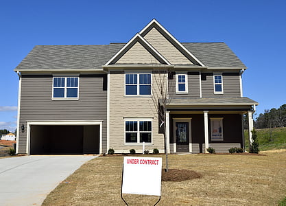 house under contract sign at the front of lawn thumbnail