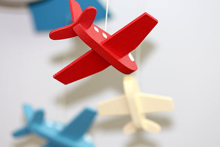 shallow focus photography of red wooden airplane hanging decoration thumbnail