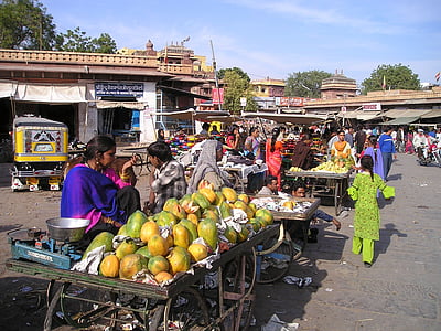 woman selling papayas during daytime thumbnail