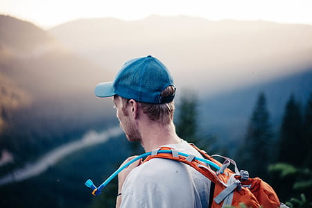 man carrying orange backpack with hydration pack thumbnail