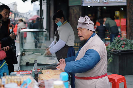 man standing in front of the table while talking to the costumer thumbnail