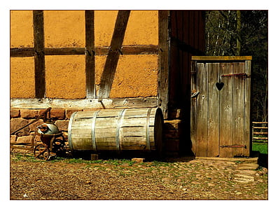 brown wooden barrel beside wall thumbnail