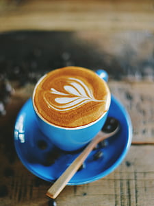 latte with foam art on blue mug thumbnail