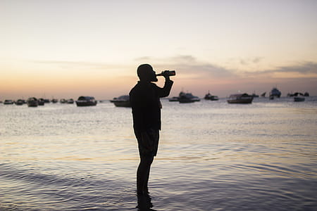 Silhouette Photo Of Man Drinking thumbnail