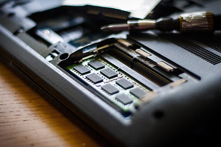 close-up photography of black electronic part on wooden surface thumbnail