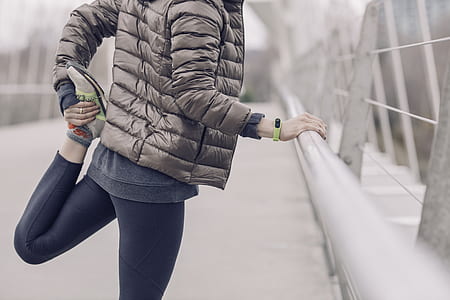 person holding leg stretching in shallow photorgraphy thumbnail